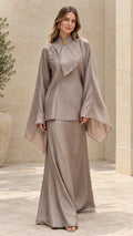 Front view of model wearing taupe draped neck tunic and maxi skirt two-piece set