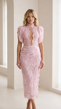 Front view of model wearing pink lace midi dress with keyhole cutout