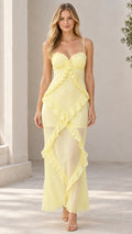 Front view of model wearing pastel yellow sweetheart cascading ruffle cami maxi dress