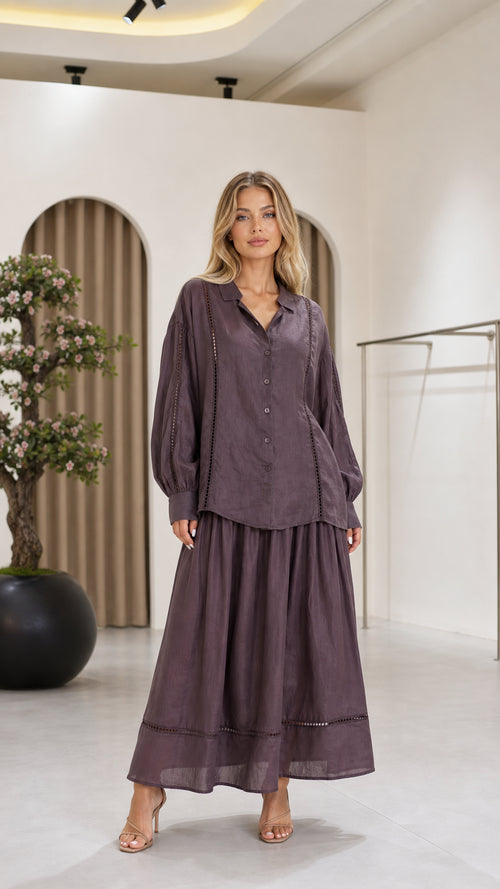 Front view of a mauve women's blouse and flowing maxi skirt two-piece set