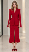 Front full view of woman wearing red tailored peplum blazer and matching lace midi skirt