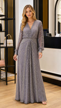 Full front view of elegant slate grey long sleeve beaded maxi evening gown