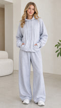 Front view of model wearing light grey 2-piece hoodie and wide leg lounge pants set