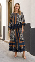 Full front view of model wearing the navy blue and caramel pleated leopard print two-piece set with lace trim