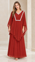 Front view of woman wearing rust red layered kaftan maxi dress with silver embroidered V-neck
