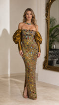 Full-length front view of woman wearing gold off-the-shoulder crystal embellished maxi gown with bronze puff sleeves
