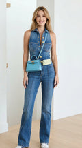 Front view of model wearing blue denim flare jumpsuit