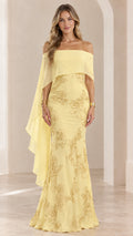Front view of woman wearing yellow off-the-shoulder cape evening gown with floral embroidery