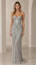 Front view of model wearing a floor-length strapless silver beaded fringe evening gown