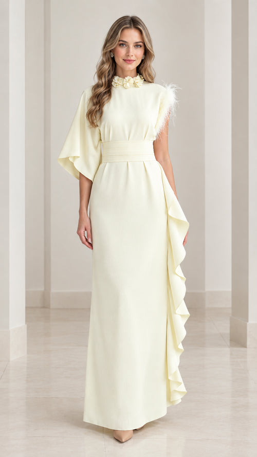 Full front view of butter yellow asymmetrical one-sleeve maxi dress with floral collar and side ruffle