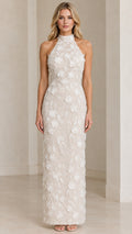Front view of model wearing Ivory 3D floral applique halter maxi evening dress