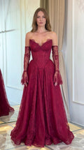 Front view of model wearing burgundy strapless floral lace corset evening gown with matching lace sleeves