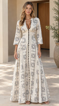 Front full view of woman wearing off-white geometric print V-neck maxi dress with 3/4 sleeves