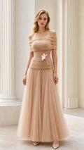 Model wearing champagne off-the-shoulder tulle corset maxi gown front view