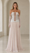 Front view of model wearing champagne strapless pearl corset evening gown with sheer gloves