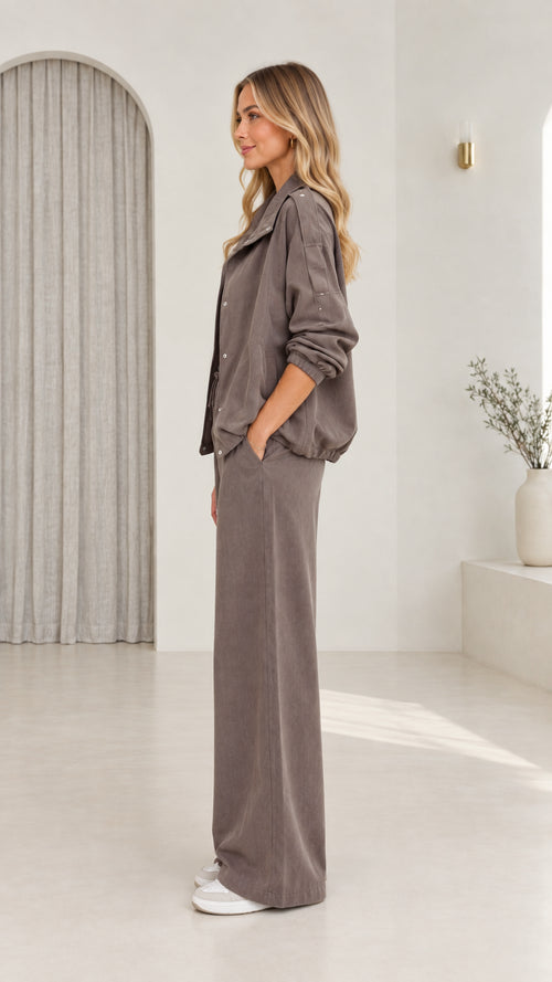 Side profile view of model in taupe casual two-piece pant set