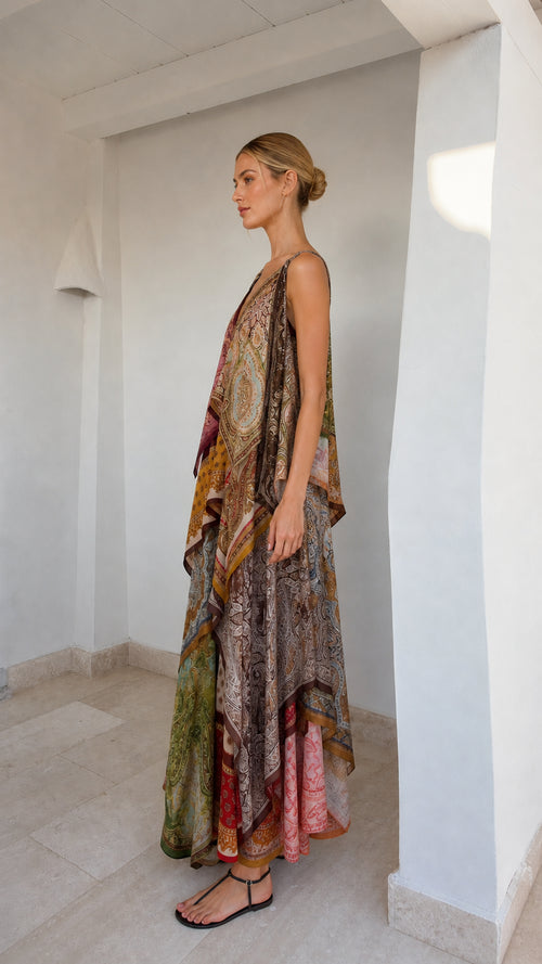 Side profile of model in flowing patchwork maxi dress