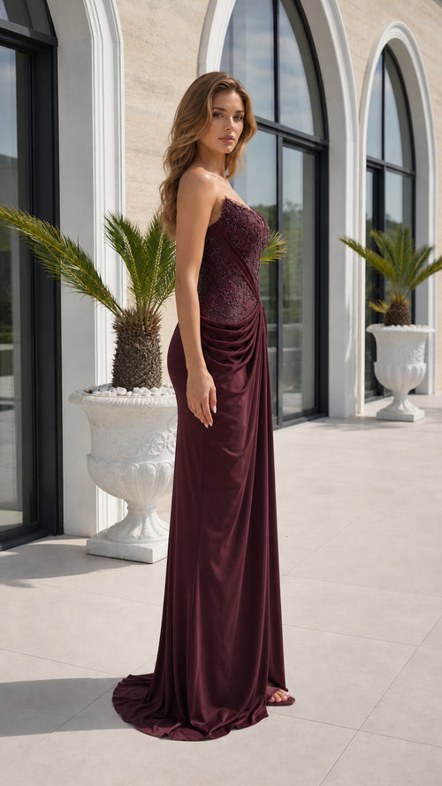 Side profile view of burgundy evening dress
